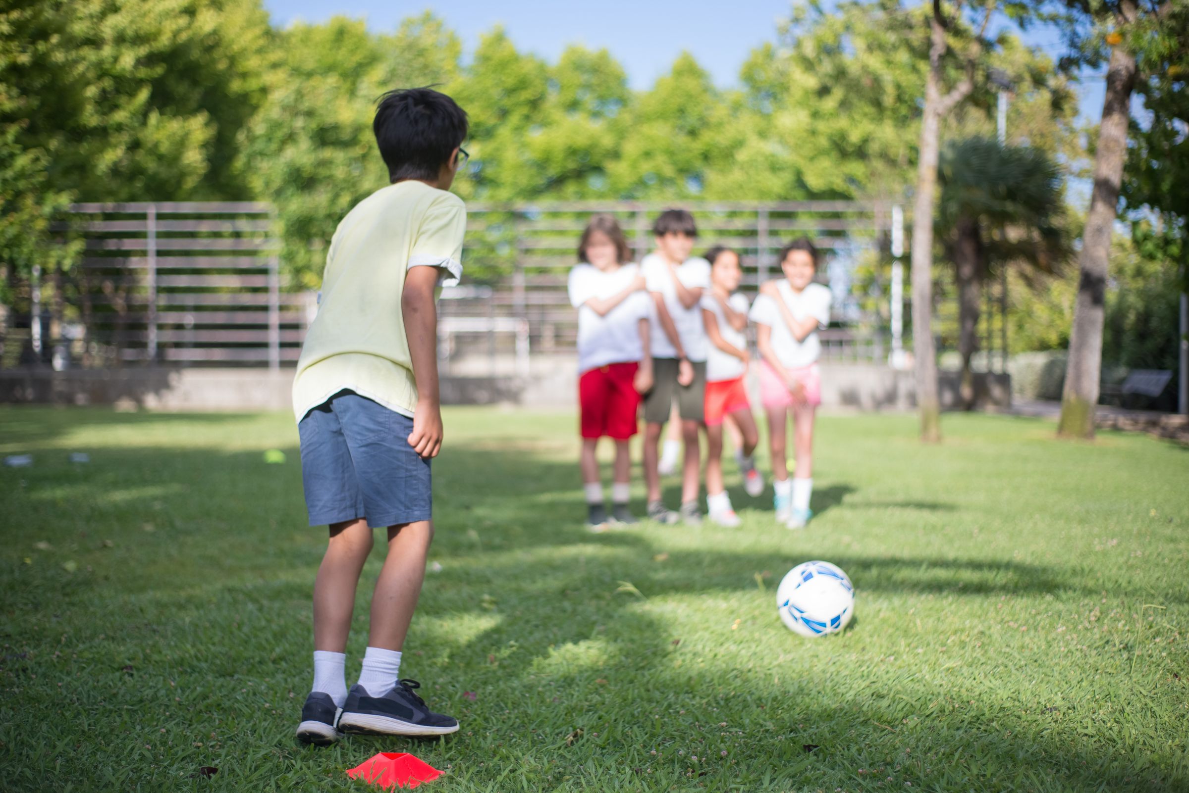 Children enjoying a group football activity outdoors